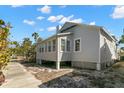 This home features a sunroom, a chimney, and sits on posts at 12404 Sunshine Ln, Treasure Island, FL 33706