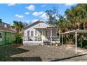 This home features a welcoming front porch and has a carport at 12404 Sunshine Ln, Treasure Island, FL 33706