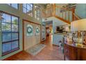 Inviting foyer with wood floors, staircase, and abundant natural light at 1439 Wetherington Way, Palm Harbor, FL 34683