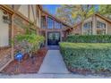 Stately brick home featuring an elegant entrance with double doors and manicured landscaping at 1439 Wetherington Way, Palm Harbor, FL 34683