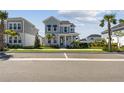 Charming two-story home features a welcoming porch, landscaped yard, and light blue accents at 1558 Merrythought Ln, Sarasota, FL 34240