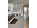 Bright kitchen featuring new white cabinets and countertops, ready for appliances and finishing touches at 1606 Marilyn Ave, Bradenton, FL 34207