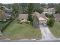 Aerial view of single-story home with well-kept lawn and mature landscaping at 1617 Cherokee Trl, Valrico, FL 33594