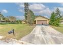 Inviting single-Gathering home with a lush green lawn, mature trees and long driveway at 1617 Cherokee Trl, Valrico, FL 33594