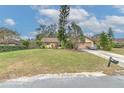 Well-maintained home with a manicured lawn, mature trees, and a spacious driveway at 1617 Cherokee Trl, Valrico, FL 33594