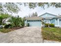 Charming single-story home with a well-manicured lawn and a two-car garage at 19200 Weymouth Dr, Land O Lakes, FL 34638