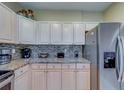Updated kitchen with stainless steel appliances, granite countertops, and modern backsplash at 19829 Gulf Blvd # 601, Indian Shores, FL 33785