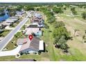 Aerial view of golf course home in a lovely residential community with mature landscaping and serene surroundings at 2007 E View Dr, Sun City Center, FL 33573