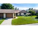 Charming single-story home with well-maintained lawn, attached garage, and inviting front entrance at 2254 Sequoia Dr, Clearwater, FL 33763