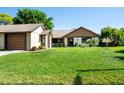 Inviting single-story home featuring a well-kept lawn, attached garage, and charming front exterior at 2254 Sequoia Dr, Clearwater, FL 33763