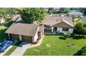 Well-maintained single-story home with a lush green lawn, an attached garage, and mature landscaping at 2254 Sequoia Dr, Clearwater, FL 33763