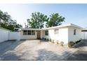 Charming single-story home featuring fresh white paint, paved driveway, and complemented by mature trees at 242 11Th Sw Ave, Largo, FL 33770