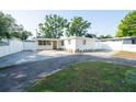 A well-kept home featuring fresh white paint, paved driveway, complemented by mature trees at 242 11Th Sw Ave, Largo, FL 33770