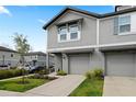 Close up of a charming two-story townhome with gray siding and an attached garage at 2760 Scarlet Bay Pl, Brandon, FL 33510