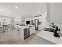 Open-concept kitchen with white cabinets, stainless steel appliances, and a center island at 2760 Scarlet Bay Pl, Brandon, FL 33510