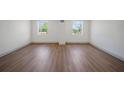 Empty bedroom with hardwood flooring and two windows at 2930 W Arch St, Tampa, FL 33607