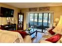 Cozy living room featuring a sliding glass door to the patio and comfortable furniture at 3161 Lake Pine S Way # H1, Tarpon Springs, FL 34688