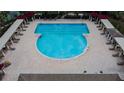 Aerial view of a large community pool with ample seating and shaded lounging areas at 3629 Bellmeade Ct, Wesley Chapel, FL 33543
