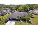 Aerial view of a lovely home with lush greenery, mature trees, and a private backyard oasis at 3994 Belmoor Dr, Palm Harbor, FL 34685