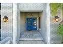 Inviting entryway features a bright blue front door with sidelights and stylish exterior lighting at 3994 Belmoor Dr, Palm Harbor, FL 34685