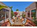 Charming outdoor patio with dining set, mature landscaping, and string lights create a cozy entertainment space at 4509 10Th N Ave, St Petersburg, FL 33713