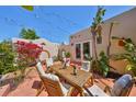Inviting patio dining area with seating for six, surrounded by lush flowers and tropical foliage at 4509 10Th N Ave, St Petersburg, FL 33713