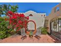 Cozy outdoor seating area with colorful flowers and artistic archway in a private courtyard at 4509 10Th N Ave, St Petersburg, FL 33713