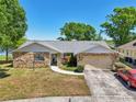 Single-story home boasts a beautiful stone facade, attached garage, and lovely landscaping at 505 Timber Pond Dr, Brandon, FL 33510