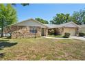 Charming single-story home with stone accents, attached garage, and a manicured front lawn at 505 Timber Pond Dr, Brandon, FL 33510