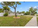Charming single-story home features lush landscaping and a convenient carport at 5103 Town N Country Blvd, Tampa, FL 33615