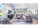 Open-concept living room boasting stylish furniture, tile flooring, and abundant natural light at 5309 Oxford Gray Rd, Wesley Chapel, FL 33545
