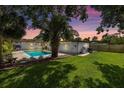 Lovely backyard with a sparkling pool, lush lawn, and beautiful landscaping, perfect for relaxing and entertaining at 1101 39Th Ne Ave, St Petersburg, FL 33703