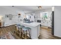 Modern kitchen featuring a marble island with seating, stainless steel appliances, and white cabinetry at 1101 39Th Ne Ave, St Petersburg, FL 33703