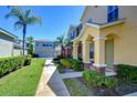 Multi-Gathering exterior view showing sidewalks, manicured lawns, and a view of garages in a residential neighborhood at 12646 Carlby Cir, Tampa, FL 33626