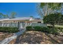 Landscaped front yard with pathway leading to inviting home entrance at 1333 Shady Pine Way # F, Tarpon Springs, FL 34688