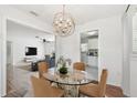 Open dining room with an elegant chandelier and glass-top table, perfect for entertaining at 1401 E North St, Tampa, FL 33604
