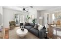 Cozy living room featuring a ceiling fan, a comfortable sofa, and access to the patio at 1401 E North St, Tampa, FL 33604