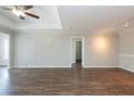 Spacious living room featuring stylish wood flooring, neutral paint, and modern lighting fixtures at 18001 Richmond Place Dr # 1032, Tampa, FL 33647