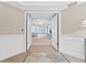 Inviting entryway with double doors leading to a spacious and well-lit interior featuring beautiful flooring at 2410 Harbourside Dr # 142, Longboat Key, FL 34228