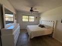 Cozy bedroom with a ceiling fan, tiled floors, a neutral color scheme, and ample natural light at 2465 Northside Dr # 604, Clearwater, FL 33761
