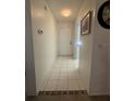Hallway featuring white tile floors with decorative trim and access to other areas of the home at 2465 Northside Dr # 604, Clearwater, FL 33761