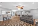 Open-concept living room with stylish furniture, modern ceiling fan, and wood-look flooring at 27103 Frampton Ave Ave, Brooksville, FL 34602
