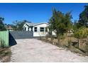 A view of the concrete driveway leading to the home, enhanced by bordering landscaping at 300 S Highland Ave, Tarpon Springs, FL 34689