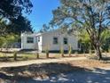Quaint single-story home surrounded by a lawn and landscaping at 300 S Highland Ave, Tarpon Springs, FL 34689