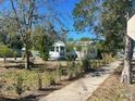 Charming single-story home with landscaping along a paved walkway at 300 S Highland Ave, Tarpon Springs, FL 34689