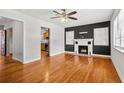 Bright living room featuring hardwood floors, a ceiling fan, fireplace, and lots of natural light at 3124 9Th N Ave, St Petersburg, FL 33713