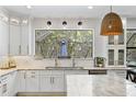 Gourmet kitchen featuring a large window, modern fixtures, and ample counter space at 3615 W Kensington Ave, Tampa, FL 33629