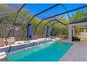 Inviting screened-in pool area with waterfalls and comfortable outdoor seating, perfect for entertaining at 3615 W Kensington Ave, Tampa, FL 33629