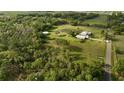 Aerial view of sprawling property featuring main house, secondary structure, pond, and surrounding landscape at 3709 Gallagher Rd, Plant City, FL 33565