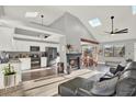 Spacious open-concept living area with vaulted ceilings, skylights, fireplace, and modern finishes at 4954 Cardinal Trl, Palm Harbor, FL 34683